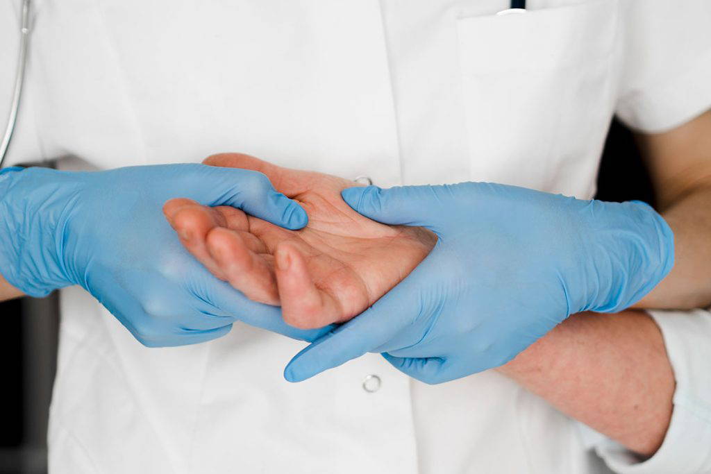 care home suppliers blue gloves being used